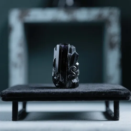 Hexagonal tourmaline crystal with vertical striations under magnification